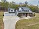 Beautifully designed two-story home featuring a brick-and-white facade, a covered porch, and three-car garage at 3078 Turning Creek Trl, Dacula, GA 30019