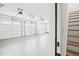 Spacious four car garage with white doors and epoxy flooring at 3078 Turning Creek Trl, Dacula, GA 30019