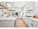 Large open kitchen features stainless appliances, a center island, and modern lighting at 3078 Turning Creek Trl, Dacula, GA 30019