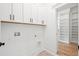 White laundry room with built in shelving and cabinets at 3078 Turning Creek Trl, Dacula, GA 30019