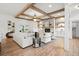 Bright living room features wood beam ceiling, stone fireplace, and lots of natural light at 3078 Turning Creek Trl, Dacula, GA 30019