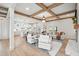 Spacious living room featuring an open floor plan with a modern kitchen and fireplace at 3078 Turning Creek Trl, Dacula, GA 30019