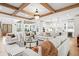 Bright, open-concept living space with hardwood floors, modern furniture, and a kitchen view at 3078 Turning Creek Trl, Dacula, GA 30019