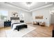 Comfortable and bright main bedroom with stylish furnishings, light wood floors, and modern lighting at 3078 Turning Creek Trl, Dacula, GA 30019