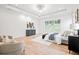 Bright main bedroom with a sitting area, large windows, and modern decor for relaxation at 3078 Turning Creek Trl, Dacula, GA 30019