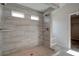 Beautiful bathroom features tile surround shower with a bench and dual shower heads in a modern space at 412 Westmarch Cir, Loganville, GA 30052