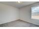 Comfortable bedroom featuring carpet flooring, a window for natural light, and neutral walls for easy personalization at 412 Westmarch Cir, Loganville, GA 30052