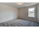 Comfortable bedroom featuring carpet flooring, a window for natural light, and neutral walls for easy personalization at 412 Westmarch Cir, Loganville, GA 30052