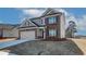 Attractive two-story home boasts brick accents, a spacious two-car garage, and a meticulously maintained yard at 412 Westmarch Cir, Loganville, GA 30052