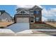 Charming two-story home with brick accents, attached two-car garage, and well-manicured lawn at 412 Westmarch Cir, Loganville, GA 30052