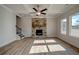 Bright living room featuring coffered ceilings, a stone fireplace, and hardwood floors, with plenty of natural light at 412 Westmarch Cir, Loganville, GA 30052