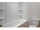 Clean tub and shower combination featuring built-in shelving for convenience and efficient space utilization at 412 Westmarch Cir, Loganville, GA 30052