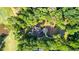 A bird's-eye view of a luxury home surrounded by trees, lawn, and a nearby golf course at 450 Birkdale Dr, Fayetteville, GA 30215