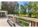 A spacious back deck and staircase overlook the green backyard and lush trees at 450 Birkdale Dr, Fayetteville, GA 30215