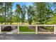 A spacious back deck with black iron railings overlooks the green backyard and lush trees at 450 Birkdale Dr, Fayetteville, GA 30215