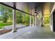 Covered back porch with white pillars, black ceiling fan, stairs to the yard, and view of the trees at 450 Birkdale Dr, Fayetteville, GA 30215