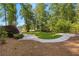 Well-manicured backyard with a curved stone walkway and landscaping at 450 Birkdale Dr, Fayetteville, GA 30215