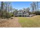 Expansive backyard view of a modern home with multiple balconies and a beautifully landscaped yard at 450 Birkdale Dr, Fayetteville, GA 30215