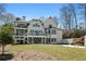 Exterior backyard view of home featuring a lawn, trees and balcony at 450 Birkdale Dr, Fayetteville, GA 30215