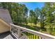 Enjoy the scenery from this balcony, overlooking lush greenery, a well-manicured lawn, and mature trees at 450 Birkdale Dr, Fayetteville, GA 30215