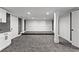 Finished basement with gray carpet, recessed lighting, and white trim on the doors and support beams at 450 Birkdale Dr, Fayetteville, GA 30215