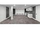 Finished basement with wet bar and cabinet, gray walls and carpet, and white trim on the doors and support beam at 450 Birkdale Dr, Fayetteville, GA 30215