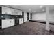 Spacious basement featuring a wet bar area, with carpet and modern lighting, perfect for entertaining or relaxing at 450 Birkdale Dr, Fayetteville, GA 30215