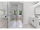 Bathroom showcasing a large walk-in shower with glass door and double vanity at 450 Birkdale Dr, Fayetteville, GA 30215