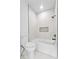 Bright bathroom featuring a tub with marble-like tile surround and dark hardware at 450 Birkdale Dr, Fayetteville, GA 30215
