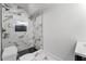Stylish bathroom featuring marble-look tile and a black-framed shower at 450 Birkdale Dr, Fayetteville, GA 30215