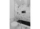 Modern shower featuring white and black tile, sleek fixtures, and minimalist design, providing a luxurious feel at 450 Birkdale Dr, Fayetteville, GA 30215