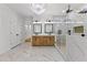 Luxurious bathroom featuring elegant chandelier, dual sinks, marble floors, and glass shower at 450 Birkdale Dr, Fayetteville, GA 30215