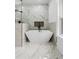 Modern soaking tub in a luxurious bathroom with marble at 450 Birkdale Dr, Fayetteville, GA 30215