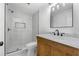 Bathroom featuring a tiled shower with glass door, sleek fixtures, and natural wood vanity, for a clean feel at 450 Birkdale Dr, Fayetteville, GA 30215