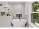 Close-up of luxurious tub with black matte faucet in an elegant bathroom at 450 Birkdale Dr, Fayetteville, GA 30215