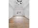 Open bedroom featuring a tray ceiling, ceiling fan, hardwood floors and large window at 450 Birkdale Dr, Fayetteville, GA 30215