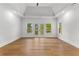 Spacious bedroom featuring hardwood floors, a ceiling fan, and multiple windows at 450 Birkdale Dr, Fayetteville, GA 30215