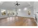 Bright bedroom with hardwood floors, fireplace, ceiling fan, and french doors to a balcony at 450 Birkdale Dr, Fayetteville, GA 30215