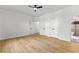 Bedroom showcasing hardwood floors, ceiling fan, access to a bathroom with glass shower, and double door closets at 450 Birkdale Dr, Fayetteville, GA 30215