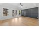 A well-lit bedroom that features hardwood floors, and exterior windows and door leading to an outside deck at 450 Birkdale Dr, Fayetteville, GA 30215