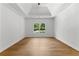 Spacious bedroom with hardwood floors and a tray ceiling complemented by a large window at 450 Birkdale Dr, Fayetteville, GA 30215