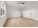 Bright bedroom featuring hardwood floors, ceiling fan and bright white walls at 450 Birkdale Dr, Fayetteville, GA 30215