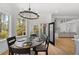 Cozy breakfast nook features a round table with seating, bright windows, and access to a patio at 450 Birkdale Dr, Fayetteville, GA 30215