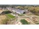 Aerial view of a clubhouse with a golf course, tennis courts, and parking area at 450 Birkdale Dr, Fayetteville, GA 30215
