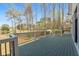 Spacious deck overlooking a serene lake and lush greenery, perfect for outdoor entertaining and relaxation at 450 Birkdale Dr, Fayetteville, GA 30215