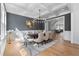 Elegant dining room featuring a coffered ceiling, stylish chandelier, and large windows for natural light at 450 Birkdale Dr, Fayetteville, GA 30215