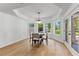 Bright dining area featuring a tray ceiling, large windows, and beautiful backyard views at 450 Birkdale Dr, Fayetteville, GA 30215
