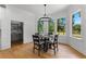Bright dining room features a modern chandelier and views of the landscaped outdoors at 450 Birkdale Dr, Fayetteville, GA 30215