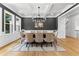 Formal dining room with elegant chandelier, large windows, and seating for eight at 450 Birkdale Dr, Fayetteville, GA 30215