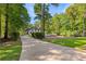 Driveway leading up to the property showcases lush landscaping, mature trees, and privacy at 450 Birkdale Dr, Fayetteville, GA 30215